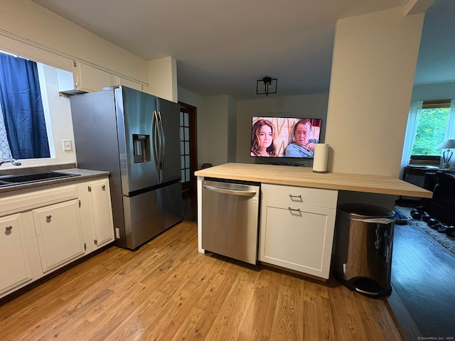 11 Arden Ave, New Fairfield, CT 06812 - kitchen with stainless steel appliances, a sink, light wood-style flooring, white cabinets, and wooden counters