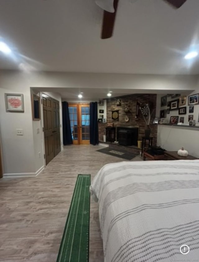 11 Arden Ave, New Fairfield, CT 06812 - bedroom with baseboards, a fireplace, light wood-type flooring, and ceiling fan