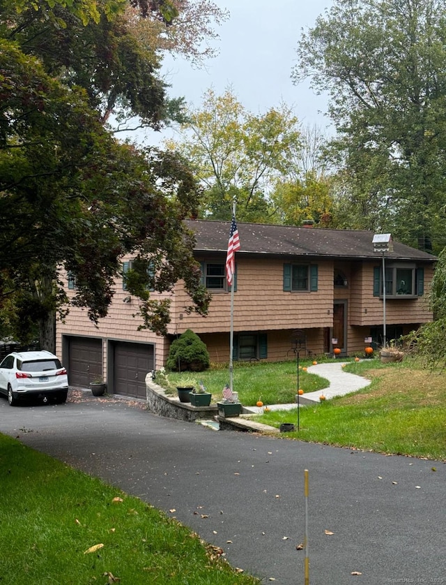 11 Arden Ave, New Fairfield, CT 06812 - view of front facade featuring asphalt driveway, a garage, and a front lawn