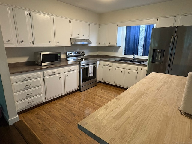 11 Arden Ave, New Fairfield, CT 06812 - kitchen with appliances with stainless steel finishes, a sink, under cabinet range hood, white cabinetry, and wood finished floors