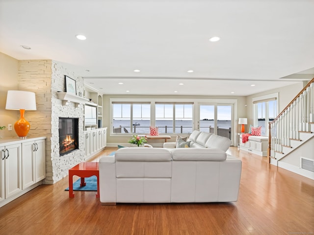 48 Harbor View Ave, Norwalk, CT 06854 - living room with light wood-type flooring, plenty of natural light, a fireplace, stairs, and recessed lighting