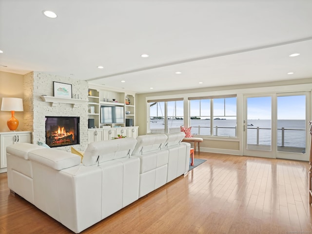 48 Harbor View Ave, Norwalk, CT 06854 - living room with a fireplace, light wood-style flooring, and recessed lighting
