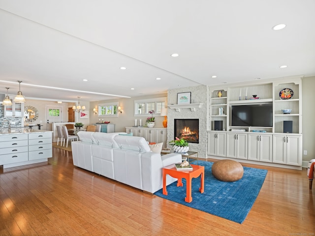 48 Harbor View Ave, Norwalk, CT 06854 - living area featuring light wood finished floors, recessed lighting, a fireplace, and a chandelier