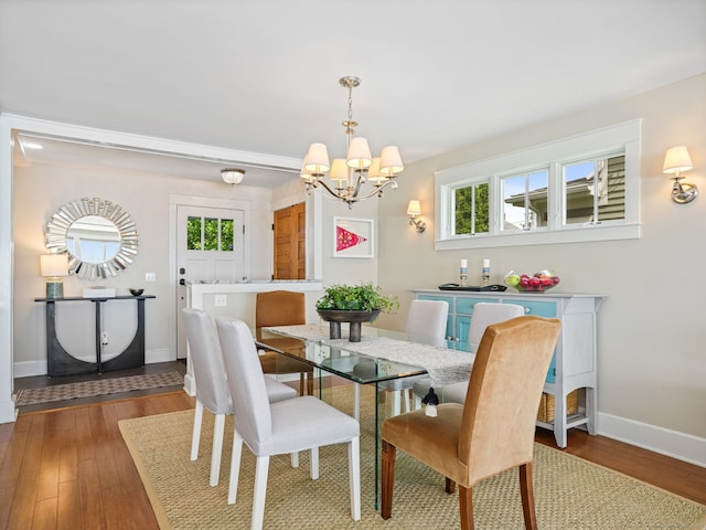48 Harbor View Ave, Norwalk, CT 06854 - dining space with a chandelier, baseboards, and wood finished floors