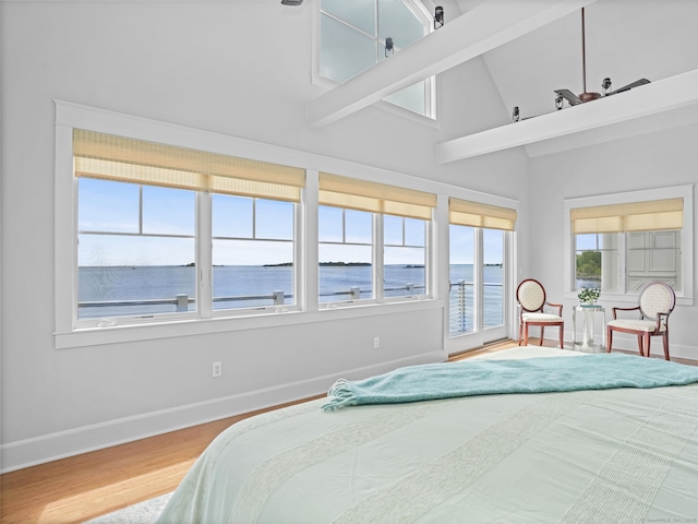 48 Harbor View Ave, Norwalk, CT 06854 - bedroom with baseboards, wood finished floors, a high ceiling, a water view, and access to exterior