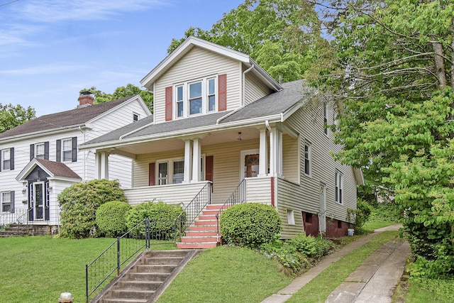 497 Commonwealth Ave, New Britain, CT 06053 - view of front of home with a front lawn, a porch, and roof with shingles