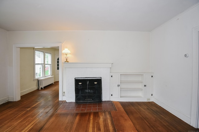 497 Commonwealth Ave, New Britain, CT 06053 - unfurnished living room featuring radiator, dark wood-style floors, baseboards, a brick fireplace, and crown molding
