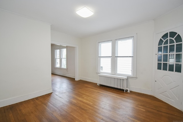 497 Commonwealth Ave, New Britain, CT 06053 - spare room with radiator heating unit, hardwood / wood-style floors, crown molding, and baseboards