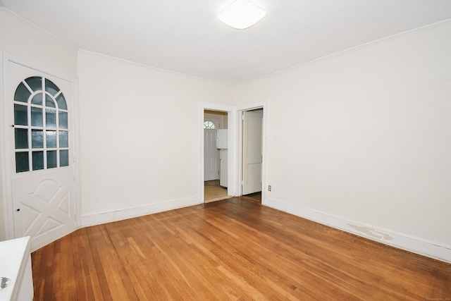 497 Commonwealth Ave, New Britain, CT 06053 - unfurnished room featuring light wood-style floors, crown molding, and baseboards