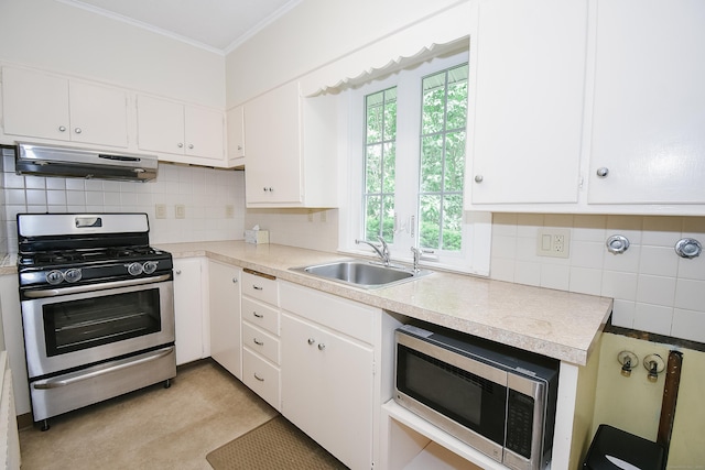 497 Commonwealth Ave, New Britain, CT 06053 - kitchen featuring under cabinet range hood, stainless steel appliances, a sink, light countertops, and ornamental molding