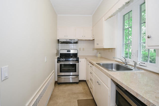 497 Commonwealth Ave, New Britain, CT 06053 - kitchen featuring gas stove, under cabinet range hood, a sink, ornamental molding, and plenty of natural light