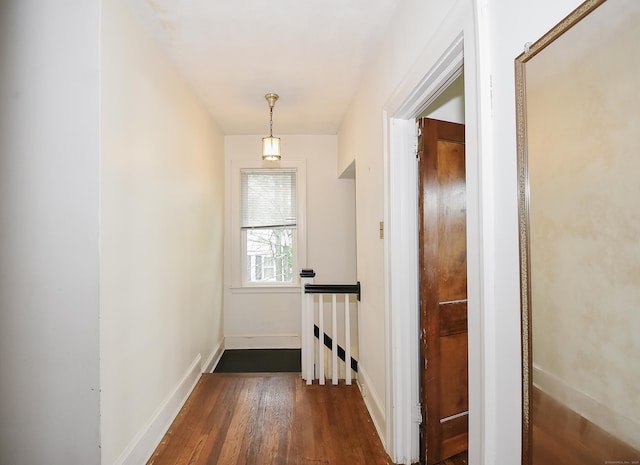 497 Commonwealth Ave, New Britain, CT 06053 - hall featuring an upstairs landing, dark wood-style flooring, and baseboards