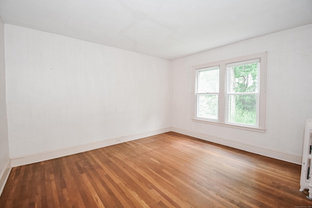 497 Commonwealth Ave, New Britain, CT 06053 - spare room featuring baseboards and wood finished floors