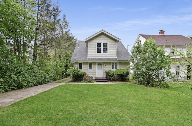 497 Commonwealth Ave, New Britain, CT 06053 - traditional-style home with a front lawn and a shingled roof