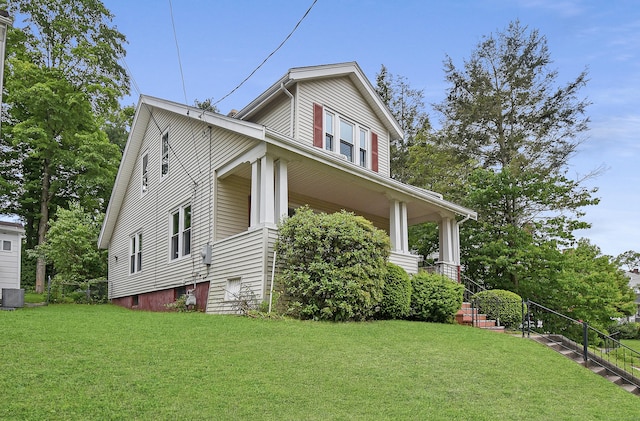 497 Commonwealth Ave, New Britain, CT 06053 - view of property exterior featuring a yard, central air condition unit, and covered porch