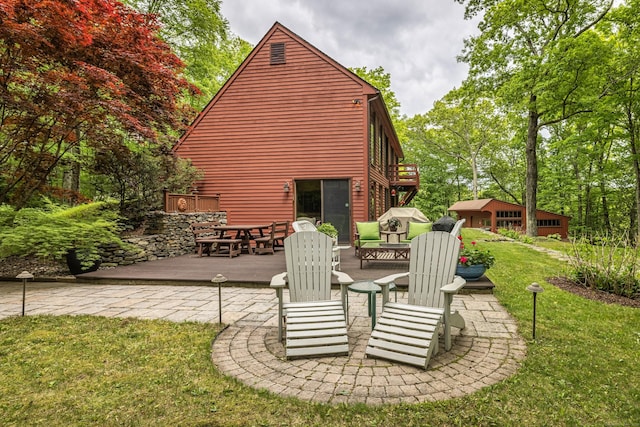 31 Philip Dr, Mansfield, CT 06268 - rear view of house with a lawn, a deck, a patio area, and a fire pit