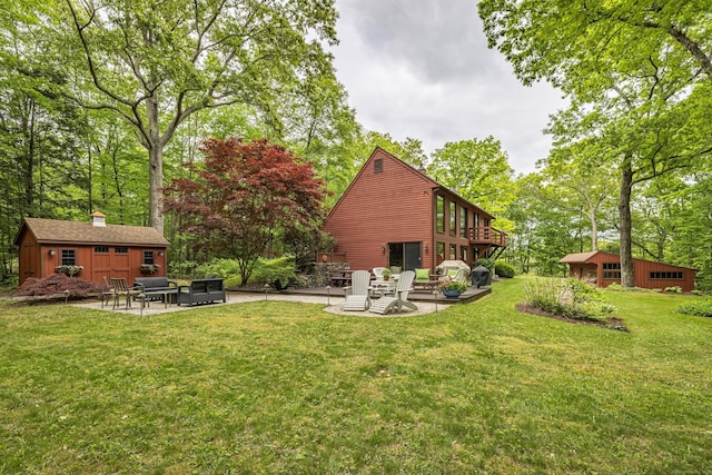 31 Philip Dr, Mansfield, CT 06268 - back of property featuring a patio area, a lawn, an outdoor structure, a deck, and view of scattered trees