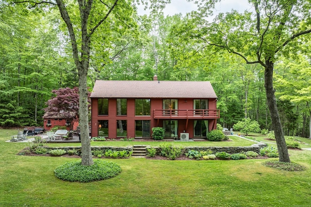 31 Philip Dr, Mansfield, CT 06268 - view of front of house featuring a front yard, a wooden deck, a patio, and a view of trees