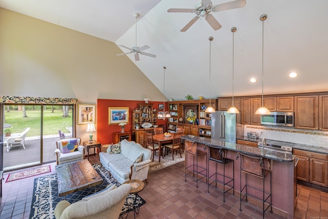 31 Philip Dr, Mansfield, CT 06268 - kitchen with appliances with stainless steel finishes, a breakfast bar area, open floor plan, high vaulted ceiling, and a ceiling fan