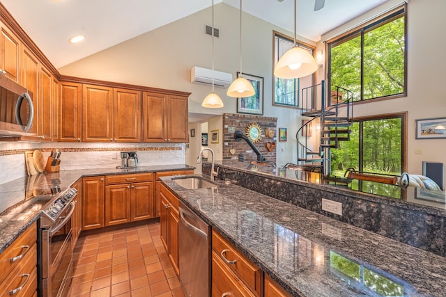 31 Philip Dr, Mansfield, CT 06268 - kitchen featuring appliances with stainless steel finishes, a sink, high vaulted ceiling, plenty of natural light, and brown cabinets