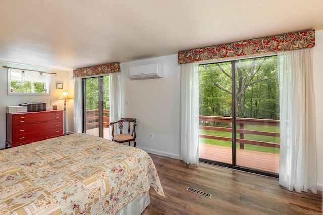 31 Philip Dr, Mansfield, CT 06268 - bedroom with a wall mounted air conditioner, access to exterior, multiple windows, and wood finished floors