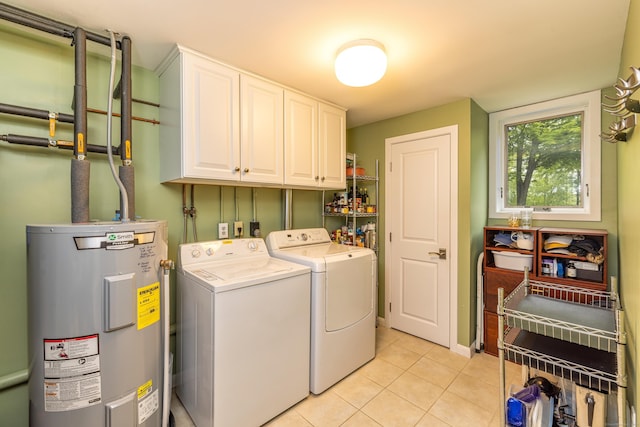 31 Philip Dr, Mansfield, CT 06268 - laundry area with electric water heater, cabinet space, washing machine and dryer, and light tile patterned flooring