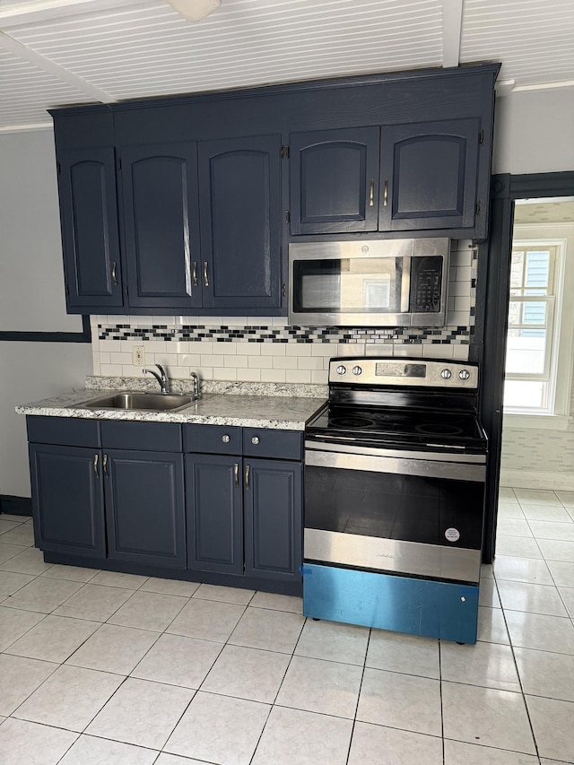 297 Laurel Ave, Bridgeport, CT 06605 - kitchen with stainless steel appliances, a sink, backsplash, and blue cabinetry
