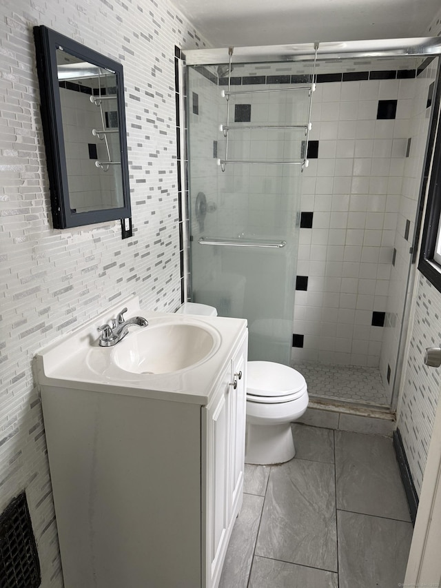 297 Laurel Ave, Bridgeport, CT 06605 - full bathroom featuring toilet, vanity, a shower stall, and marble look tiles
