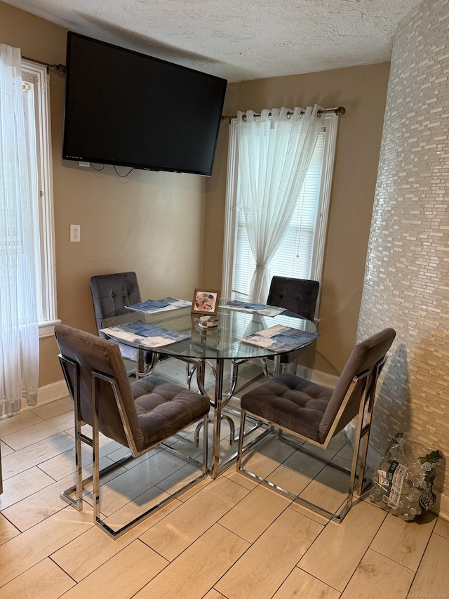 297 Laurel Ave, Bridgeport, CT 06605 - dining area featuring wood tiled floors and a textured ceiling