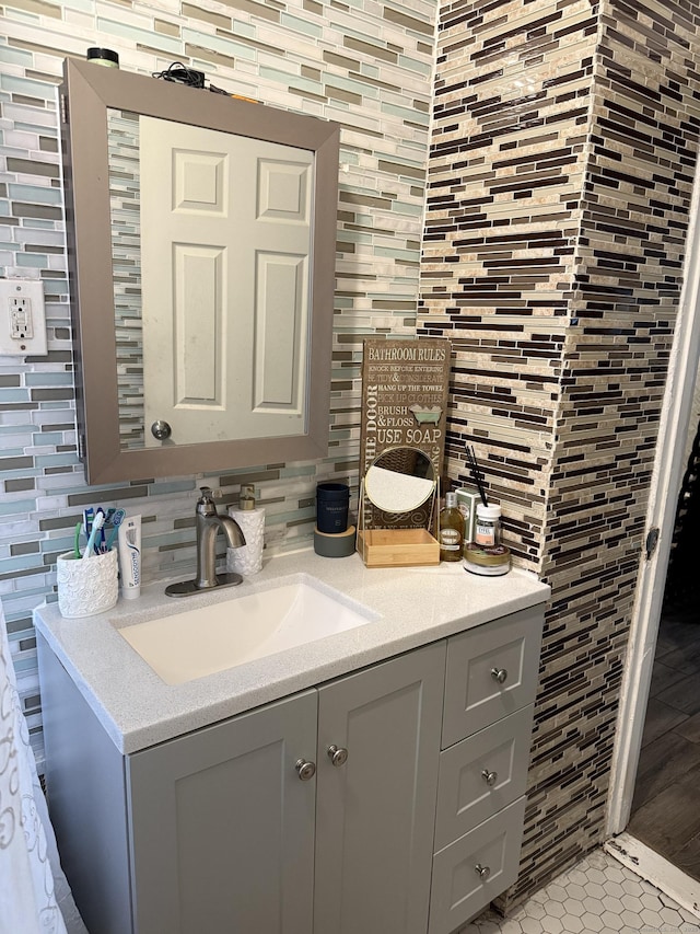 297 Laurel Ave, Bridgeport, CT 06605 - bathroom with vanity, decorative backsplash, tile walls, and tile patterned flooring
