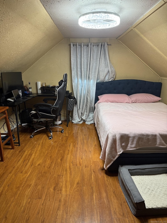 297 Laurel Ave, Bridgeport, CT 06605 - bedroom featuring lofted ceiling, a textured ceiling, wood finished floors, and an office area