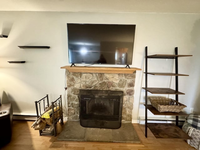 140 Hamden Ave Apt C, Waterbury, CT 06704 - detailed view of wood finished floors, baseboard heating, and a fireplace