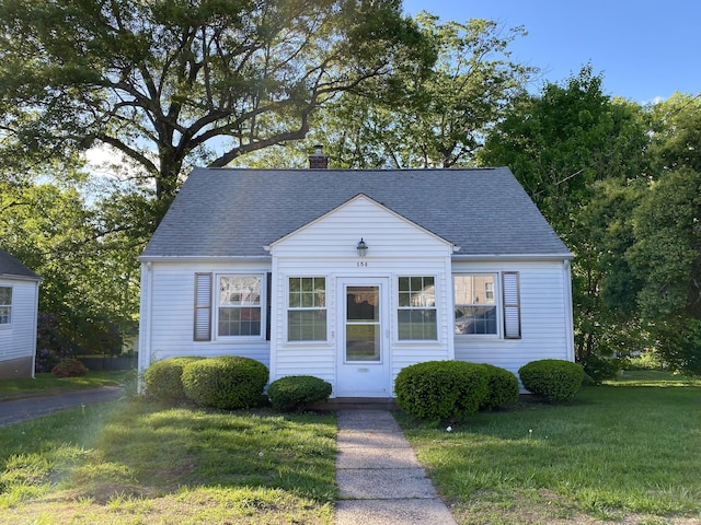 154 Wall St, Meriden, CT 06475 - view of front of home featuring a front lawn, a chimney, and a shingled roof