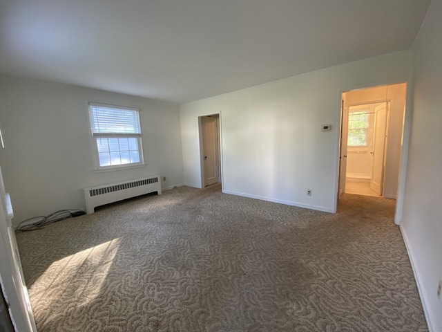154 Wall St, Meriden, CT 06475 - carpeted empty room featuring radiator heating unit and baseboards
