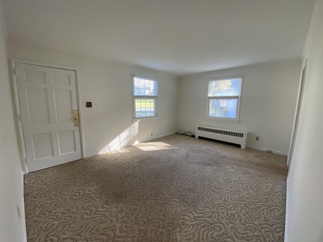 154 Wall St, Meriden, CT 06475 - empty room with radiator heating unit, carpet flooring, healthy amount of natural light, and baseboards