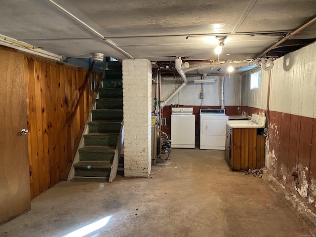 154 Wall St, Meriden, CT 06475 - basement featuring wooden walls, stairs, and washing machine and clothes dryer