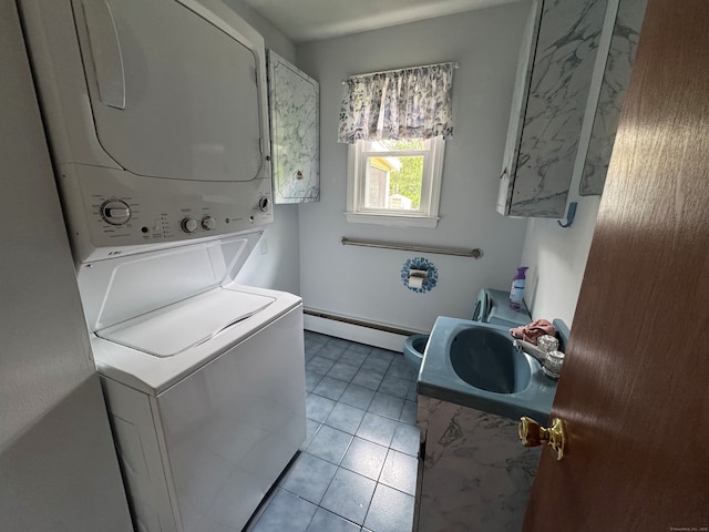 15 Zolan Dr, East Haven, CT 06513 - laundry area featuring stacked washer and clothes dryer, a baseboard heating unit, and light tile patterned floors