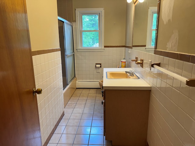 15 Zolan Dr, East Haven, CT 06513 - full bath with tile walls, tile patterned floors, a baseboard heating unit, wainscoting, and toilet