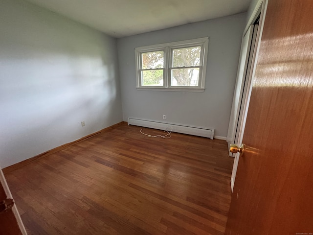 15 Zolan Dr, East Haven, CT 06513 - unfurnished bedroom featuring baseboard heating, wood finished floors, baseboards, and a closet