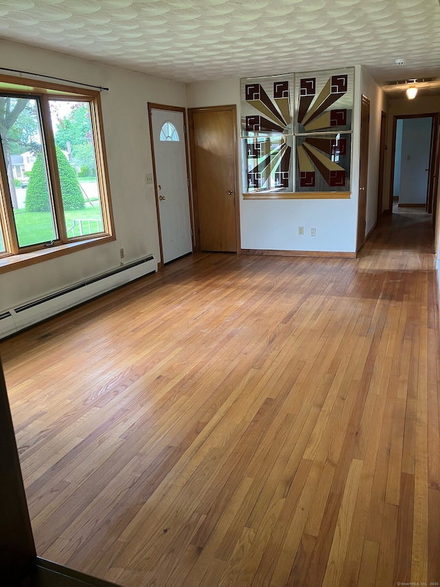 15 Zolan Dr, East Haven, CT 06513 - foyer with baseboard heating and hardwood / wood-style flooring