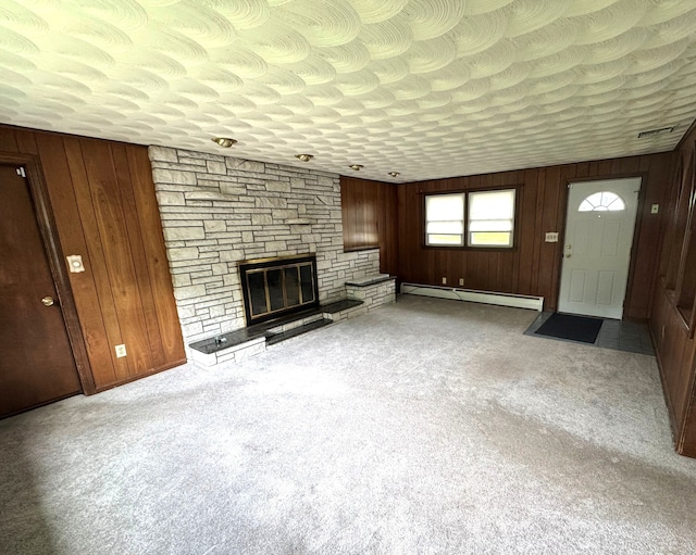 15 Zolan Dr, East Haven, CT 06513 - unfurnished living room with baseboard heating, wooden walls, a fireplace, and carpet floors
