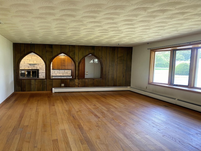 15 Zolan Dr, East Haven, CT 06513 - empty room with wood finished floors, a baseboard radiator, and wooden walls