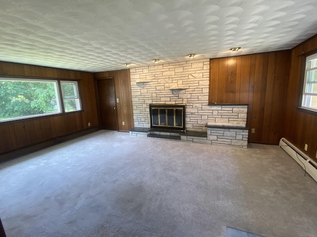 15 Zolan Dr, East Haven, CT 06513 - unfurnished living room with healthy amount of natural light, wood walls, a fireplace, and carpet floors