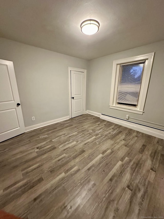 40 Dewey St, New Britain, CT 06051 - unfurnished bedroom with dark wood-style floors, baseboards, and baseboard heating