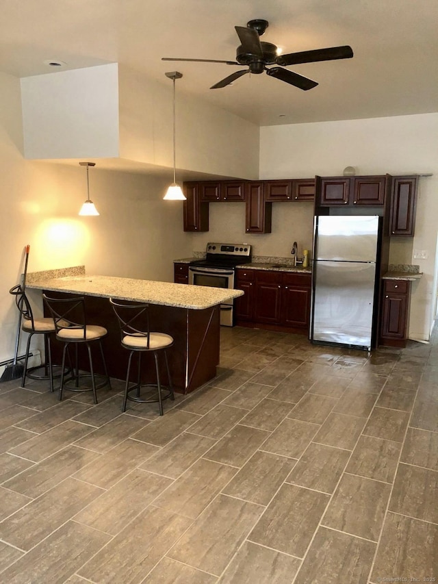 40 Dewey St, New Britain, CT 06051 - kitchen with stainless steel appliances, a sink, a ceiling fan, dark brown cabinetry, and a peninsula