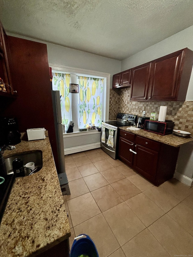 40 Dewey St, New Britain, CT 06051 - kitchen featuring appliances with stainless steel finishes, tasteful backsplash, a textured ceiling, light tile patterned floors, and dark brown cabinetry