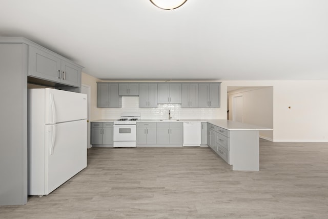 24 Newtown Tpke, Redding, CT 06896 - kitchen with white appliances, gray cabinets, a peninsula, light countertops, and a sink