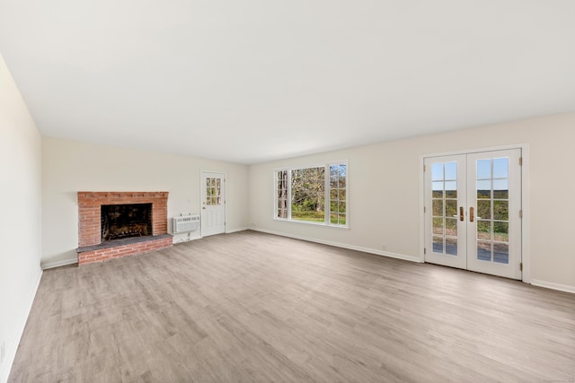 24 Newtown Tpke, Redding, CT 06896 - unfurnished living room with french doors, wood finished floors, baseboards, and a wall mounted AC