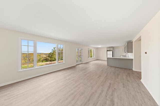 24 Newtown Tpke, Redding, CT 06896 - unfurnished living room featuring light wood-style floors and baseboards