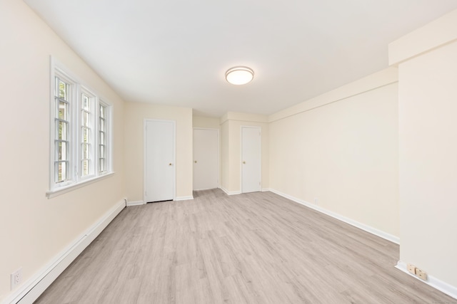 24 Newtown Tpke, Redding, CT 06896 - empty room featuring a baseboard heating unit, light wood-style floors, and baseboards